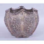 A THAI EMBOSSED AND CHASED LOBED SILVER BASKET, with embossed and chased panels of deities and