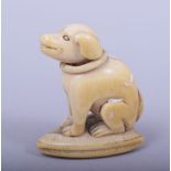A JAPANESE MEIJI PERIOD CARVED IVORY NETSUKE - DOG AND SHELL, the dog sat in recumbent pose upon a