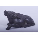 A JAPANESE MEIJI PERIOD CARVED WOOD NETSUKE - RECUMBENT OXEN, the oxen laid pose, signed
