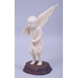 A JAPANESE MEIJI PERIOD CARVED IVORY OKIMONO - FISHERMAN, the boy stood holding his catch and net,