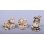 THREE JAPANESE MEIJI PERIOD CARVED IVORY NETSUKES, two signed, one of daruma, one of a man and gourd