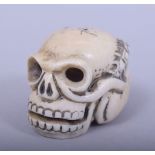 A JAPANESE MEIJI PERIOD CARVED IVORY NETSUKE - SKULL, the skull with a millipede climbing out of the