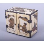 A JAPANESE MEIJI PERIOD CARVED IVORY MINIATURE CABINET, with lacquer decoration of figures and