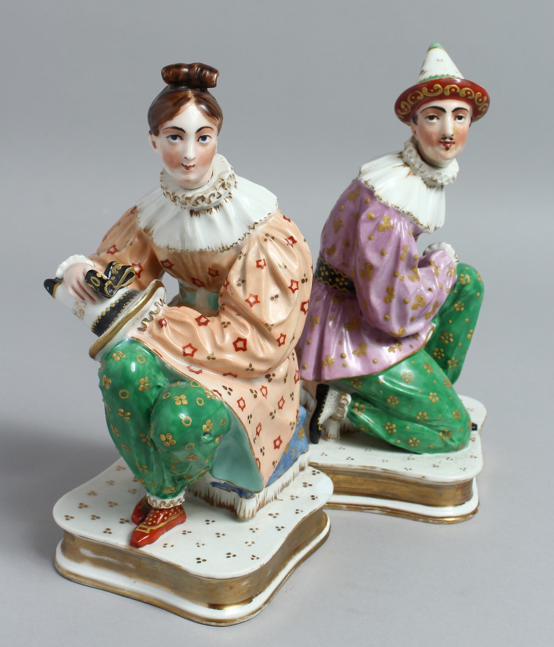 A PAIR OF JACOB PETIT PORCELAIN FIGURES with detachable heads, on square bases. 9ins high.
