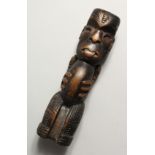 A SMALL CARVED WOOD TRIBAL FIGURE, possibly Maori. 7ins high.