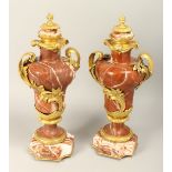A SUPERB PAIR OF LOUIS XVITH RED MARBLE AND ORMOLU, TWO HANDLED URNS on an octagonal marble base.