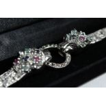A SILVER RUBY EMERALD, SAPPHIRE PANTHER BRACELET.