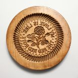 A LARGE WOODEN CIRCULAR BUTTER MOULD "My love is like a red rose". 10ins diameter.