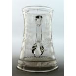 AN EARLY GLASS TANKARD engraved with flowers. T Warhurnt 5.5ins high.