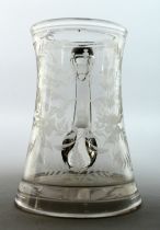 AN EARLY GLASS TANKARD engraved with flowers. T Warhurnt 5.5ins high.