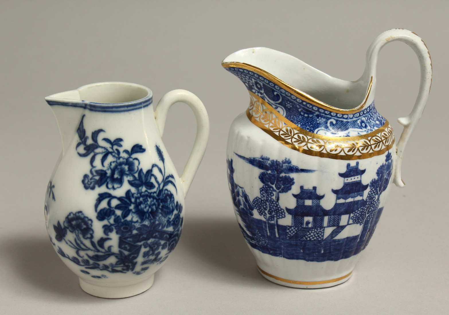 AN 18TH CENTRUY CAUGHLEY JUG printed with the Fence pattern and a Late Caughley jug printed with a