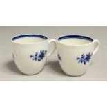 AN 18TH CENTURY CAUGHLEY PAIR OF COFFEE CUPS of uncommon shape with kick handle terminus painted