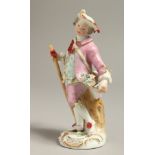 A MEISSEN FIGURE OF A MAN holding a stick with his coat tails full of flowers, c. 1760.
