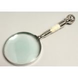 A MAGNIFYING GLASS WITH CHROME AND MOTHER OF PEARL HANDLE.