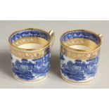 A PAIR OF STAFFORDSHIRE BLUE, WHITE AND GILT COFFEE CANS with rare handles, circa. 1815.