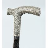 A VICTORIAN WALKING STICK with ornate silver handle. London 1899 36ins long