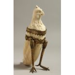 AN UNUSUAL EUROPEAN IVORY TOOTH CARVING with the head of an eagle with gilt mounted legs. 4.75ins