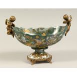 A FRENCH PORCELAIN AND ORMOLU TWO HANDLED OVAL PEDESTAL BOWL. 11ins diameter.