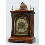 A GEORGE III DESIGN WALNUT CASED BRACKET CLOCK, with an eight day movement striking on a gong, brass
