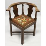 A GEORGIAN CHERRYWOOD CORNER CHAIR with two splats and a drop in needlework seat.