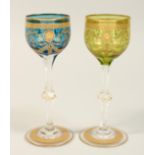 A PAIR OF GILT DECORATED WINE GLASSES. 7.75ins high.