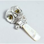 A SILVER AND MOTHER OF PEARL BABY'S RATTLE