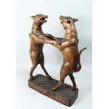 A GOOD 19TH CENTURY BLACK FOREST TWO HOUNDS STICK STAND, two dogs on a rustic base. 27ins high.
