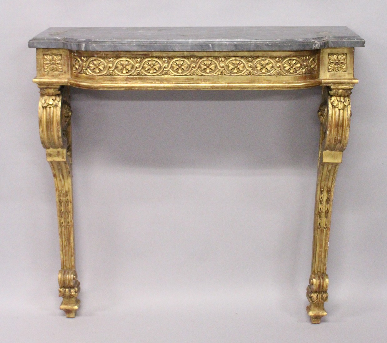 A GOOD 19TH CENTRUY MARBLE AND CARVED GILTWOOD CONSOLE TABLE with a bow fronted top, floral and