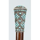 A VICTORIAN WALKING CANE with silver and turquoise handle. 36ins long.