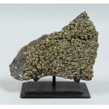 A PYRITE SPECIMEN on a stand.