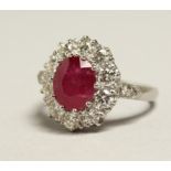 A VERY GOOD 18CT WHITE GOLD RUBY AND DIAMOND CLUSTER RING