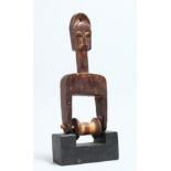 A CARVED WOOD TRIBAL PULLEY 9.5ins