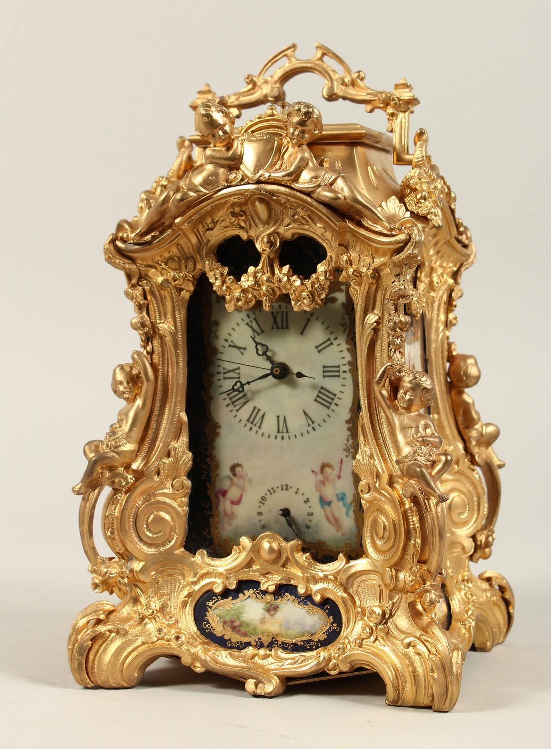 A LARGE LOUIS XVITH STYLE SEVRES ORMOLLU CLOCK with painted porcelain panels, cupid mounts and