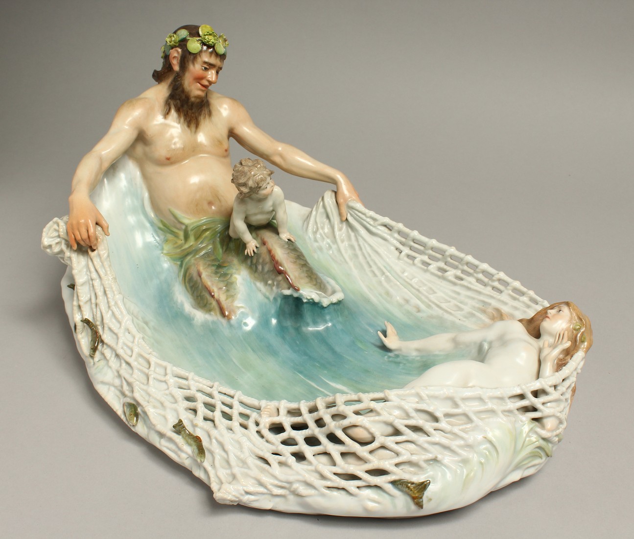 A SUPERB LARGE ART DECO MEISSEN PORCELAIN DISH as NEPTUNE pulling a fishing net with cupid and nymph