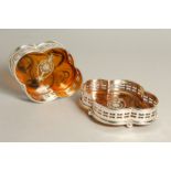 A PAIR OF SILVER PLATE AND FAUX TORTOISESHELL QUATREFOIL WINE COASTERS.