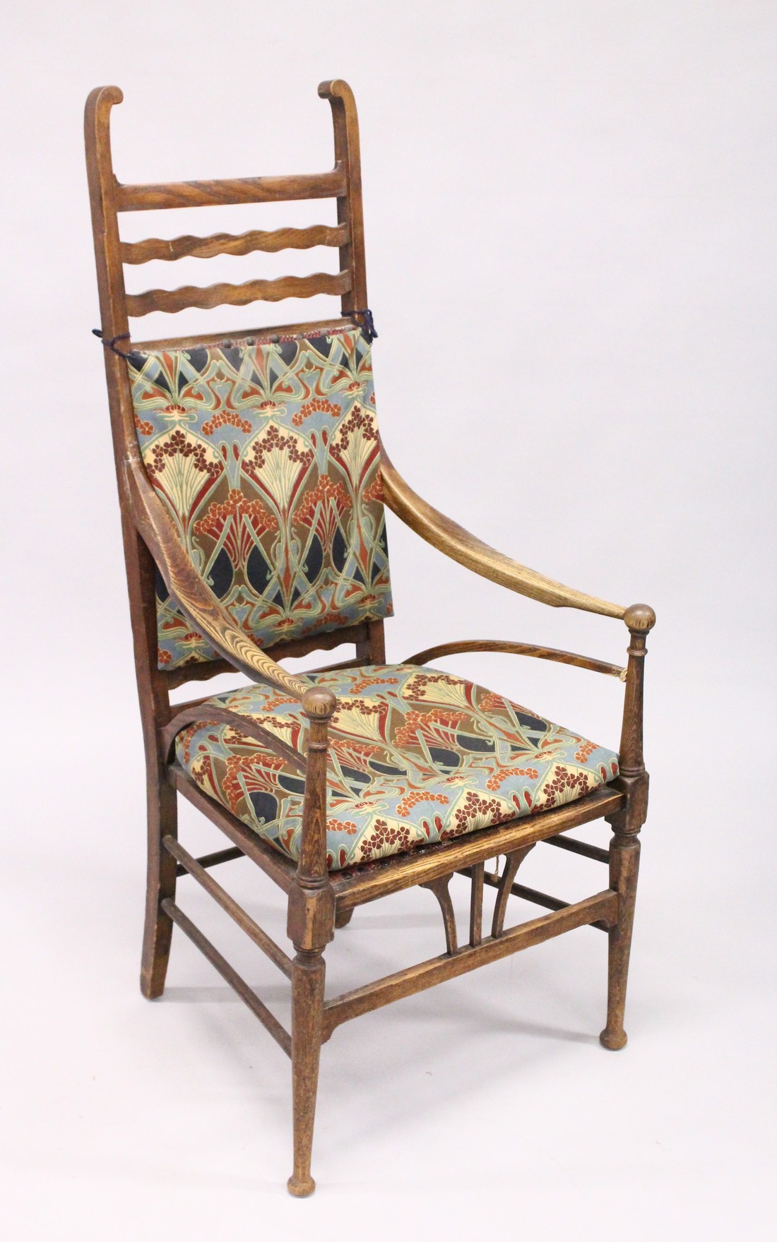 A GOOD LIBERTY RUSTIC ARM CHAIR with Liberty print padded back and seat.