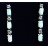 A PAIR OF SILVER AND GILSON OPAL LONG EAR RINGS.