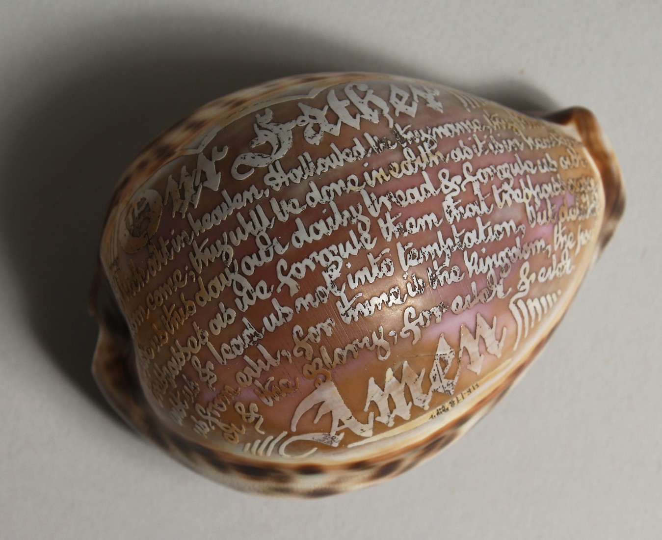 A SHELL CARVED WITH THE LORD'S PRAYER. 3ins.