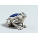 A CAST SILVER FROG PIN CUSHION.