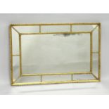 A 19TH CENTURY GILT FRAMED RECTANGULAR MIRROR, the central mirror within ten mirror slips. 2ft 11.