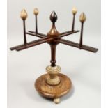 A VICTORIAN WOOD AND ALABASTER WOOL WINDER. 14ins high.