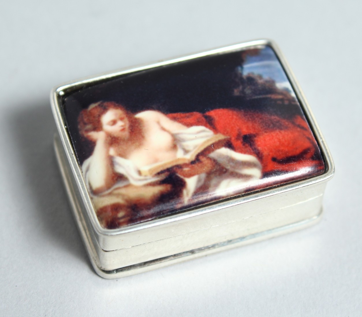 A SILVER NUDE PILL BOX.