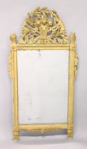 A 19TH CENTURY GILTWOOD PIER MIRROR, the cresting carved as a basket of fruit, foligae and tools,