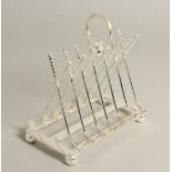 A SILVER PLATE GOLFING SIX DIVISION TOAST RACK with cross clubs and ball.