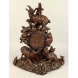 A VERY GOOD 19TH CENTURY BLACK FOREST CARVED WOOD MANTLE CLOCK, with eight day movements, striking