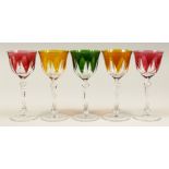 A SET OF FIVE CUT GLASS WINE GLASSES, comprising: a pair of amber tinted, a pair of ruby tinted, a