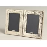 A PAIR OF SILVER PHOTOGRAPH FRAMES in the art nouveau style 7.5s x 6.5ins.