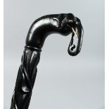 A CEYLONESE EBONY WALKING STICK with elephant handle. 33ins long.