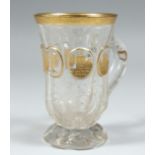 A GOOD CLEAR GLASS BOHEMIAN TANKARD with four gllt oval panels of buildings 4.5ins high.