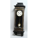 A LATE VICTORIAN EBONISED VIENNA WALL CLOCK, with eight day movement striking on a gong, white